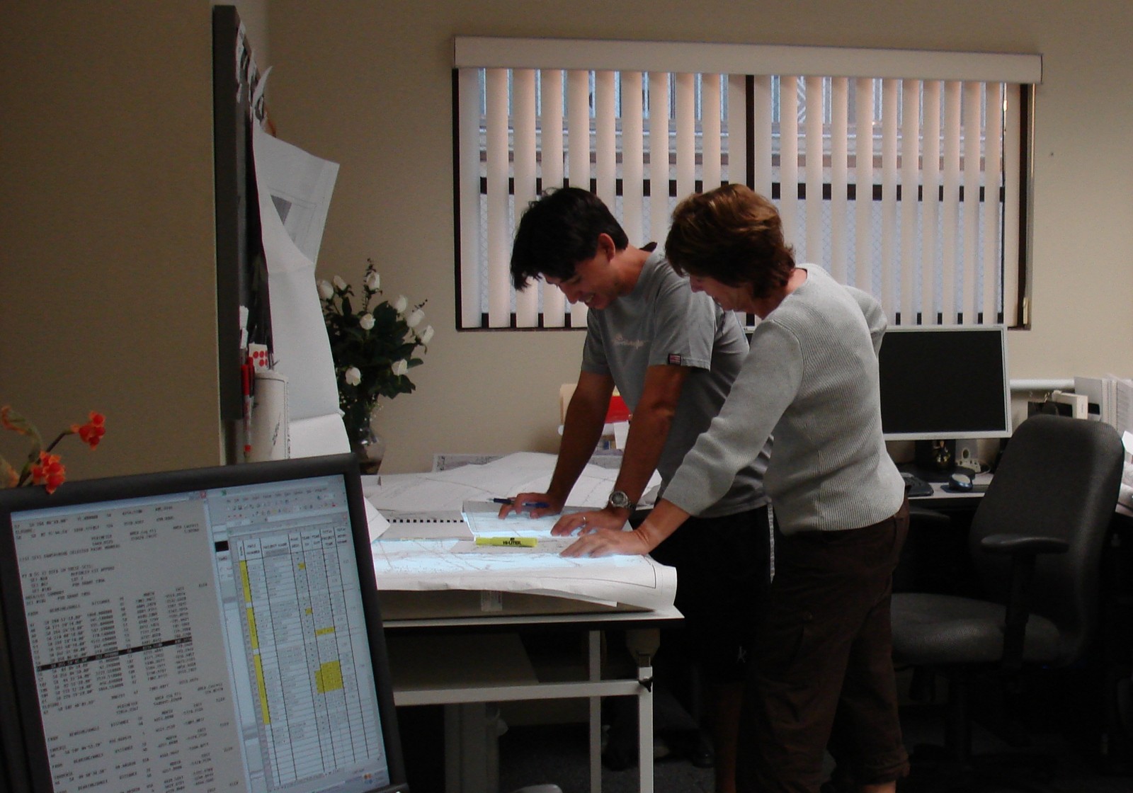 Chrystal and Nicolas Yamasaki reviewing plans in the Kailua-Kona office